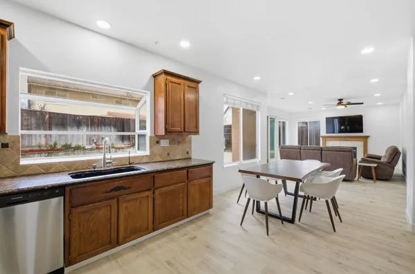 a kitchen with stainless steel appliances granite countertop a refrigerator and a stove top oven