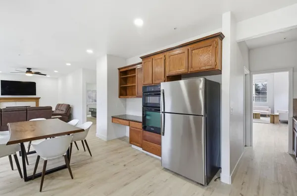a kitchen with stainless steel appliances granite countertop a refrigerator sink and cabinets