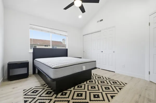 a bedroom with a bed and a tv