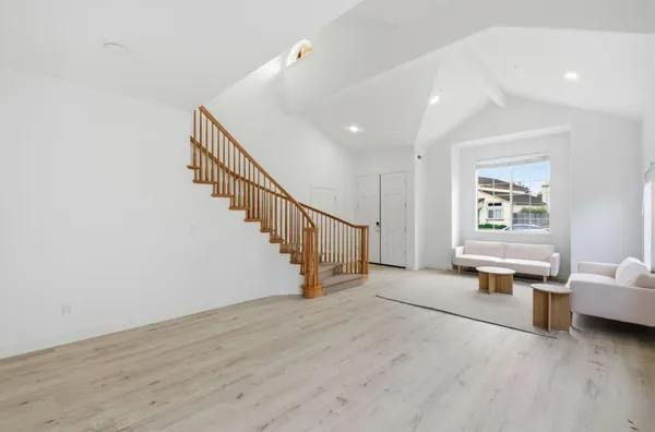 an empty room with entrance and windows