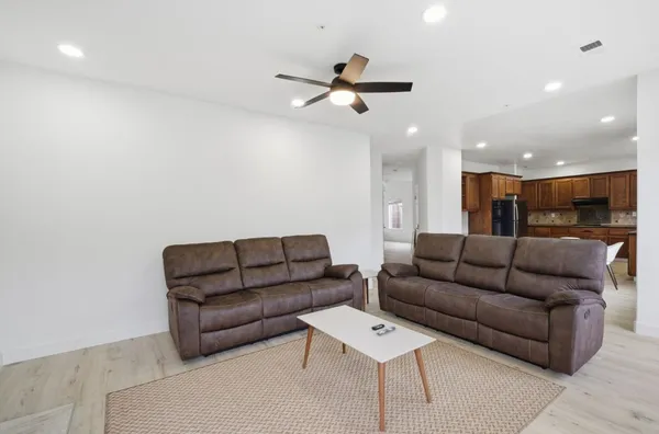 a living room with furniture a fireplace and a flat screen tv