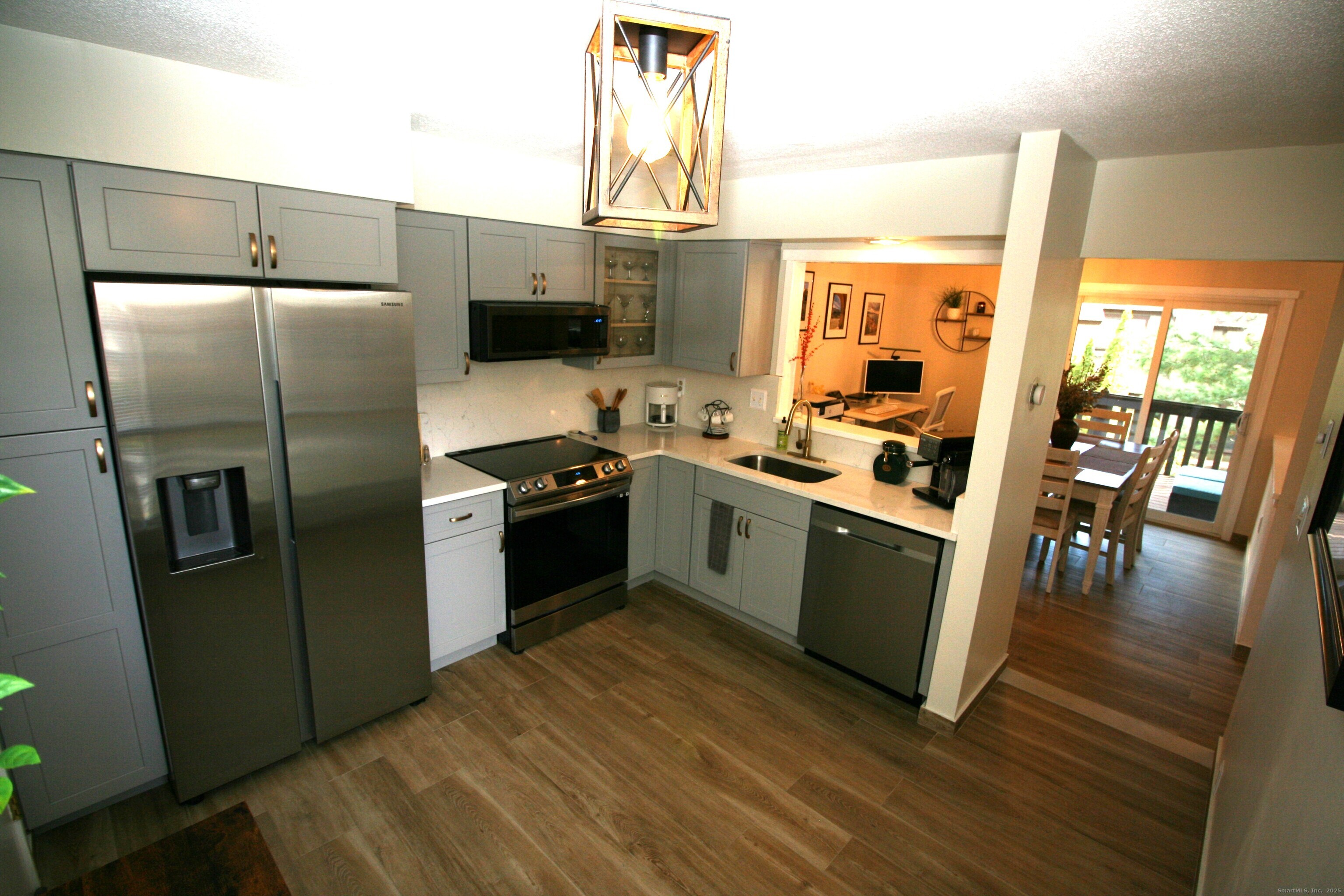 7 Twin Oak Court, Unit 7 Avon, CT 06001 - Photo 11 of 32 a kitchen with stainless steel appliances a stove a sink a refrigerator and island