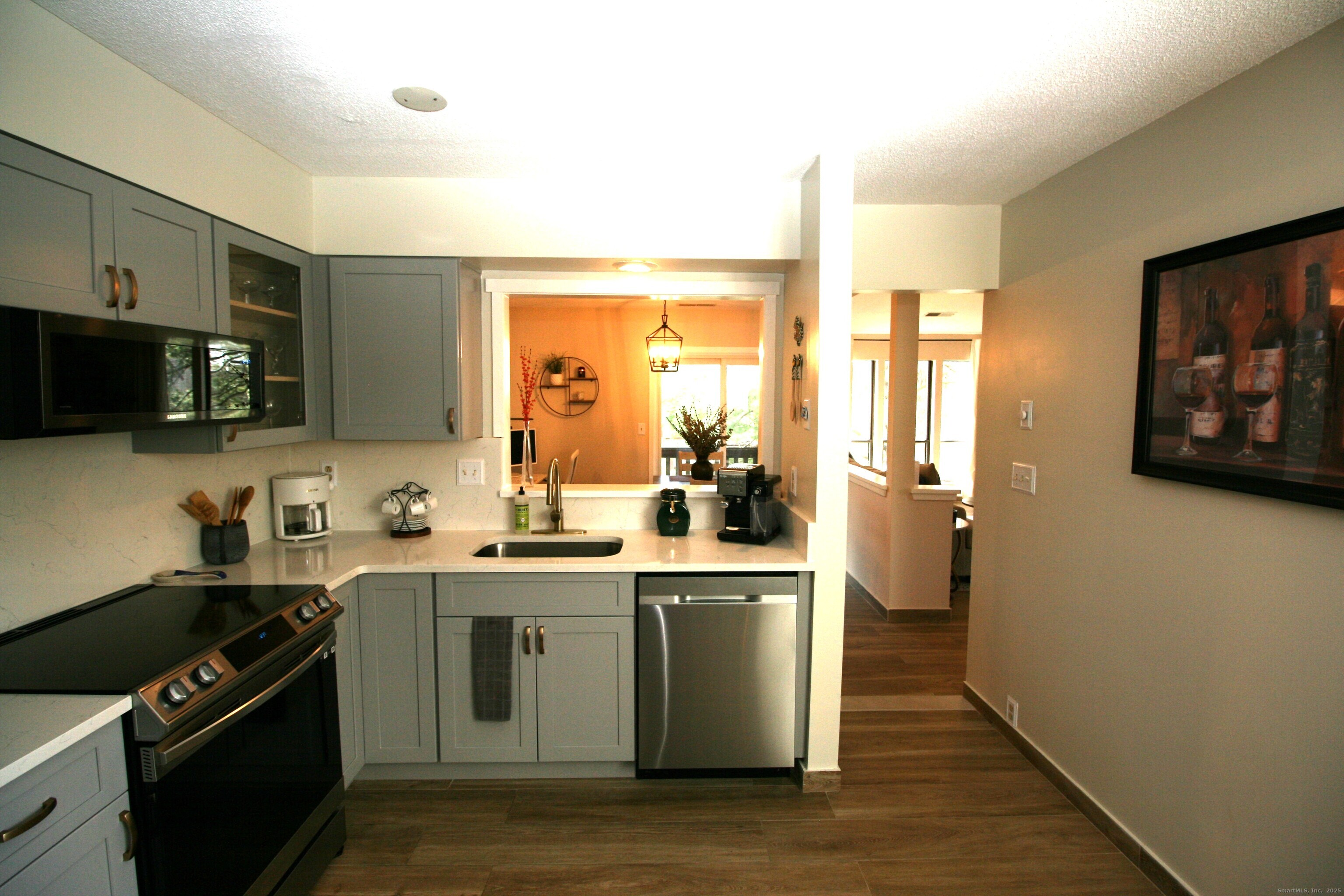 7 Twin Oak Court, Unit 7 Avon, CT 06001 - Photo 12 of 32 a kitchen with stainless steel appliances a sink a stove cabinets and wooden floor