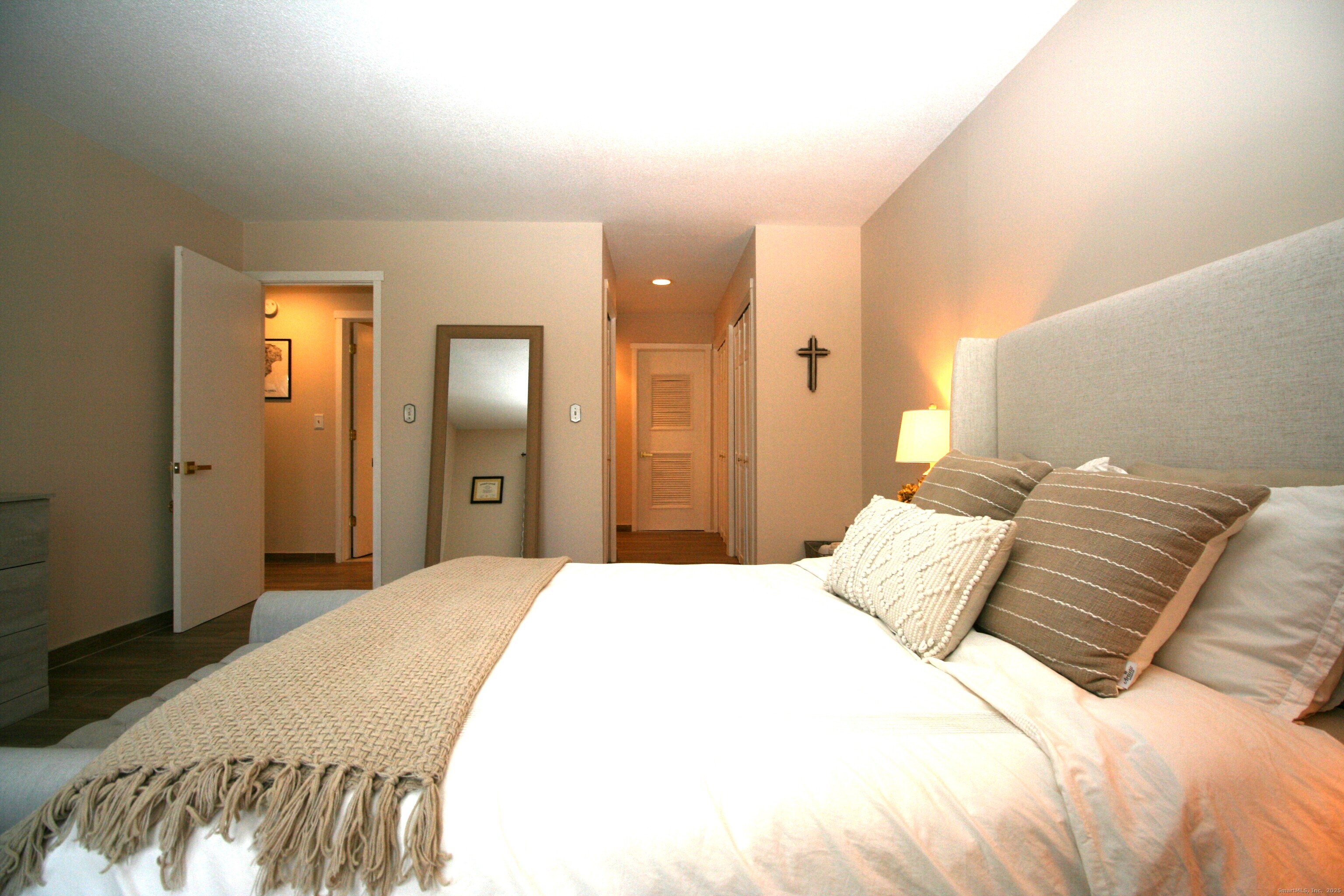 7 Twin Oak Court, Unit 7 Avon, CT 06001 - Photo 15 of 32 a bedroom with a bed and a mirror