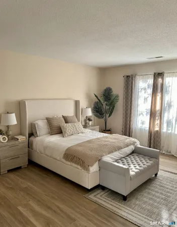 a bedroom with a large bed and a couch