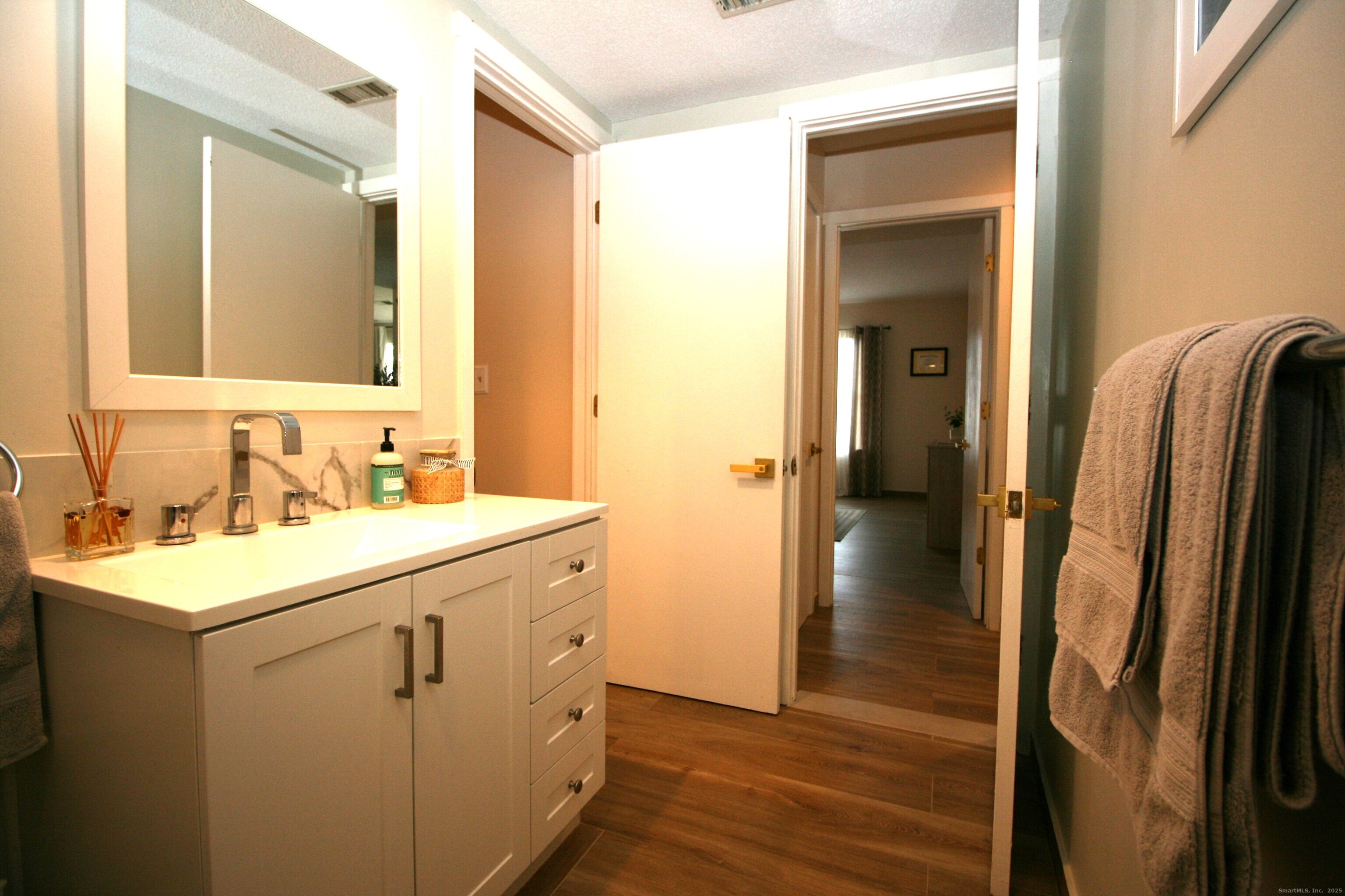 7 Twin Oak Court, Unit 7 Avon, CT 06001 - Photo 20 of 32 a bathroom with a sink and a mirror