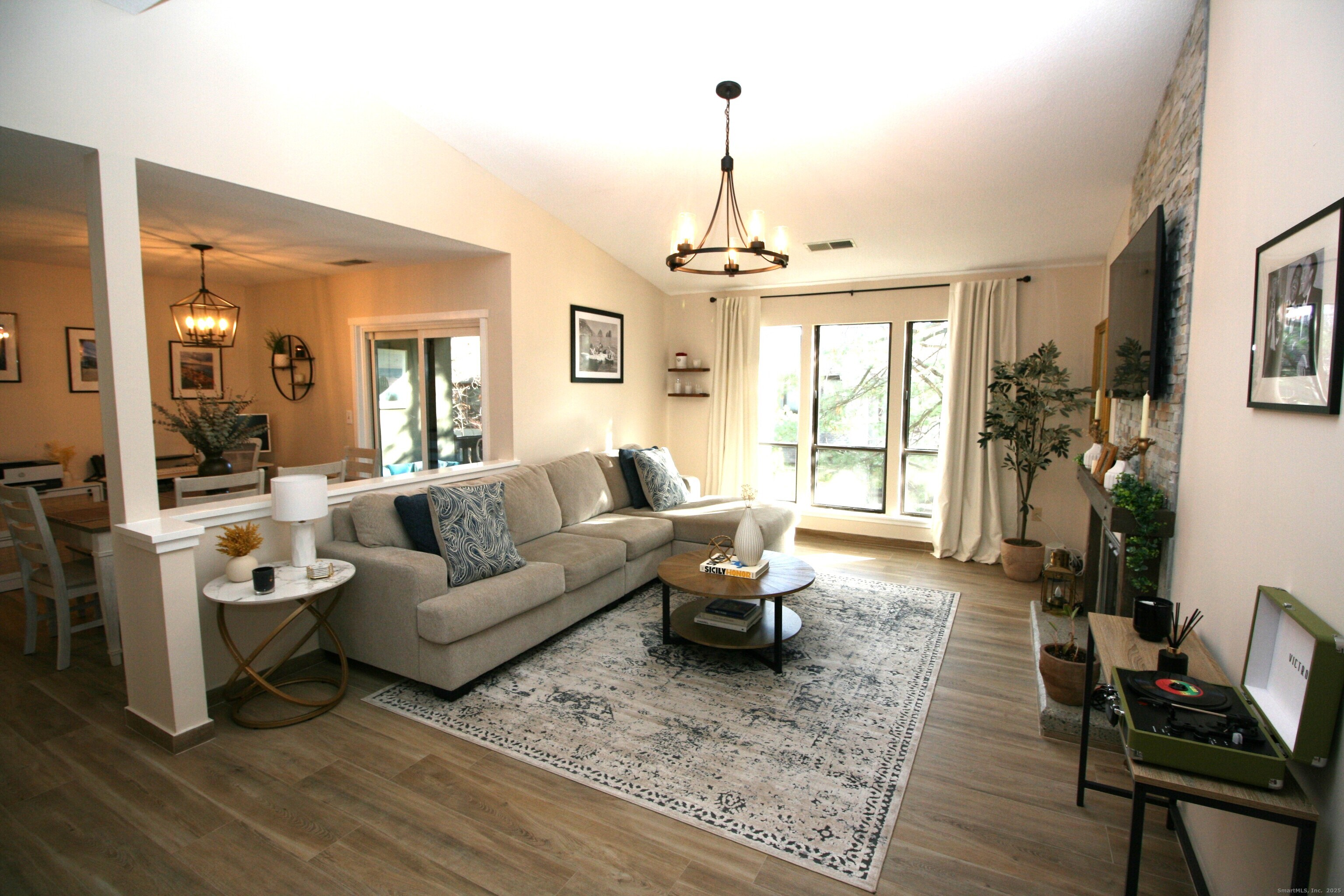 7 Twin Oak Court, Unit 7 Avon, CT 06001 - Photo 3 of 32 a living room with furniture and a chandelier