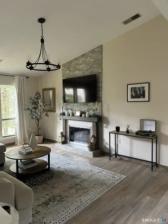 a living room with furniture and a fireplace