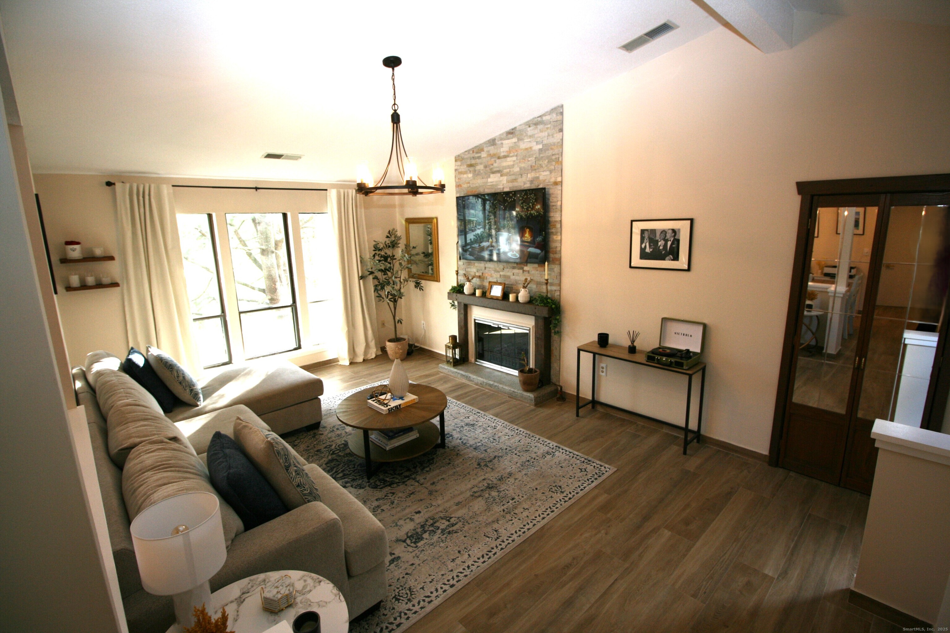 7 Twin Oak Court, Unit 7 Avon, CT 06001 - Photo 5 of 32 a living room with furniture fireplace and a flat screen tv