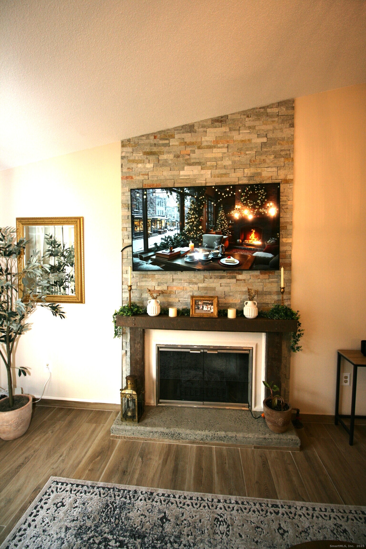 7 Twin Oak Court, Unit 7 Avon, CT 06001 - Photo 6 of 32 a living room with a fireplace and a flat screen tv