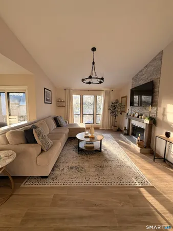 a living room with furniture and a chandelier