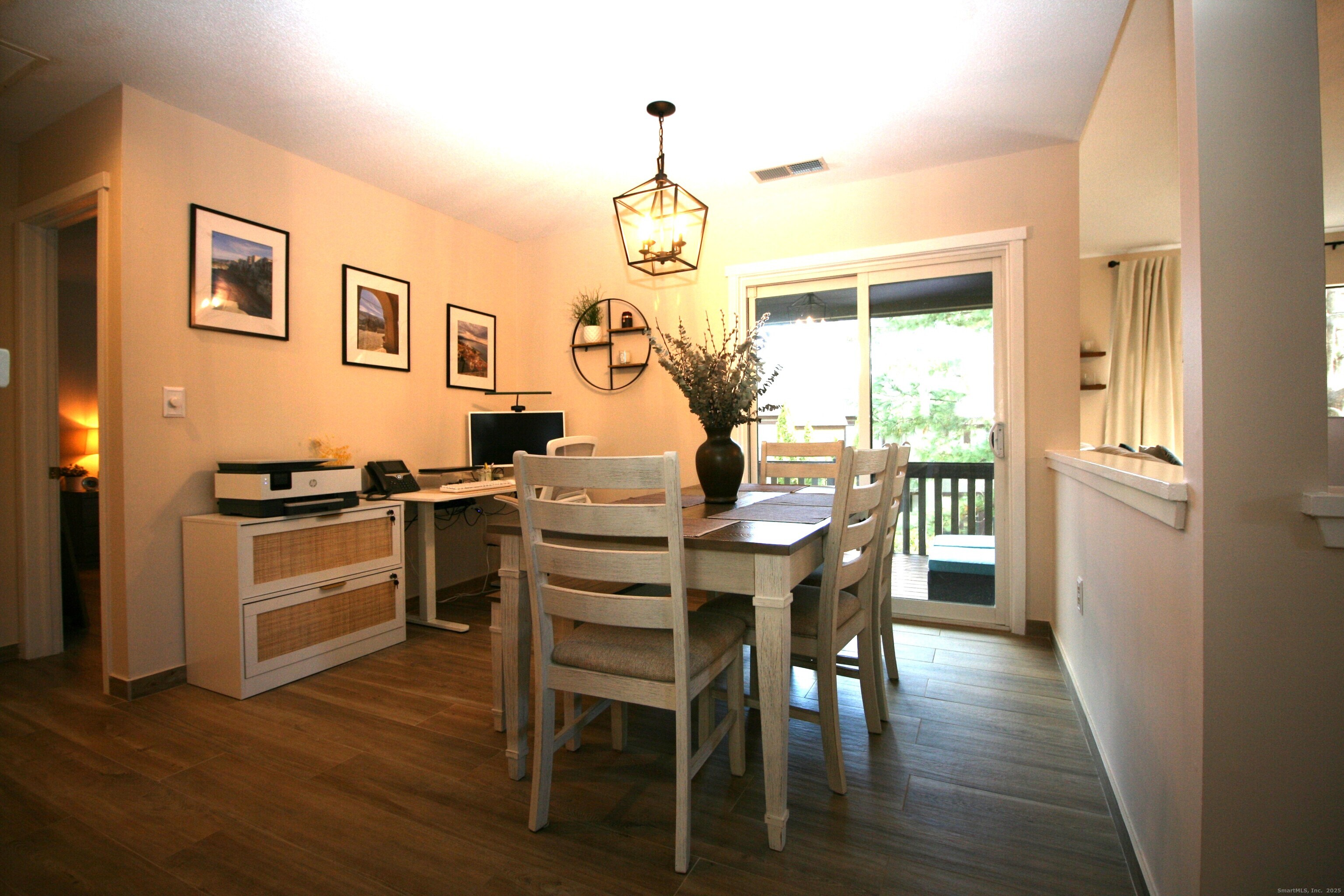 7 Twin Oak Court, Unit 7 Avon, CT 06001 - Photo 7 of 32 a kitchen with a table chairs refrigerator and cabinets