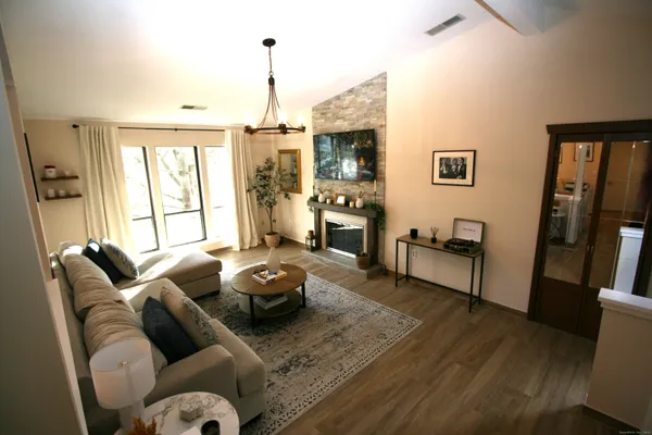 a living room with furniture fireplace and a flat screen tv