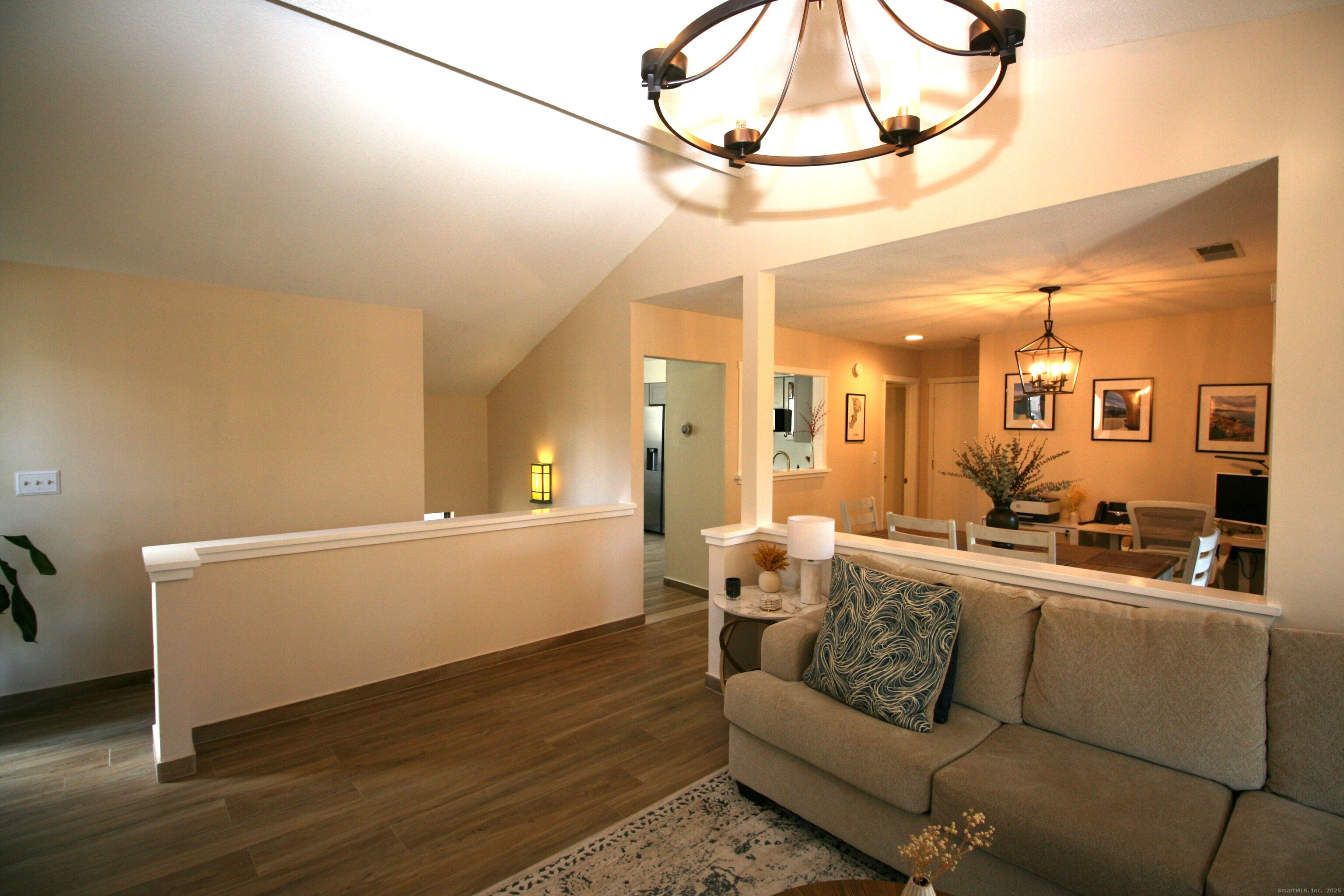 7 Twin Oak Court, Unit 7 Avon, CT 06001 - Photo 10 of 32 a living room with furniture and a chandelier