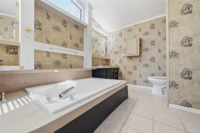 a bathroom with a bathtub sink mirror and toilet