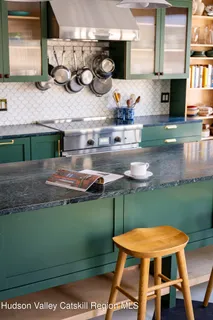 a kitchen with stainless steel appliances granite countertop a sink a stove and wooden cabinets