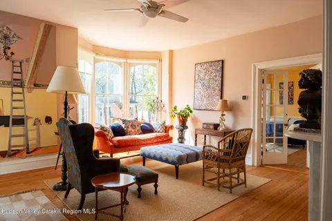 a dining room with furniture window and wooden floor