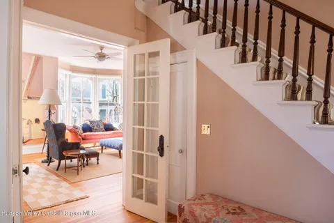 a view of entryway and hall with wooden floor