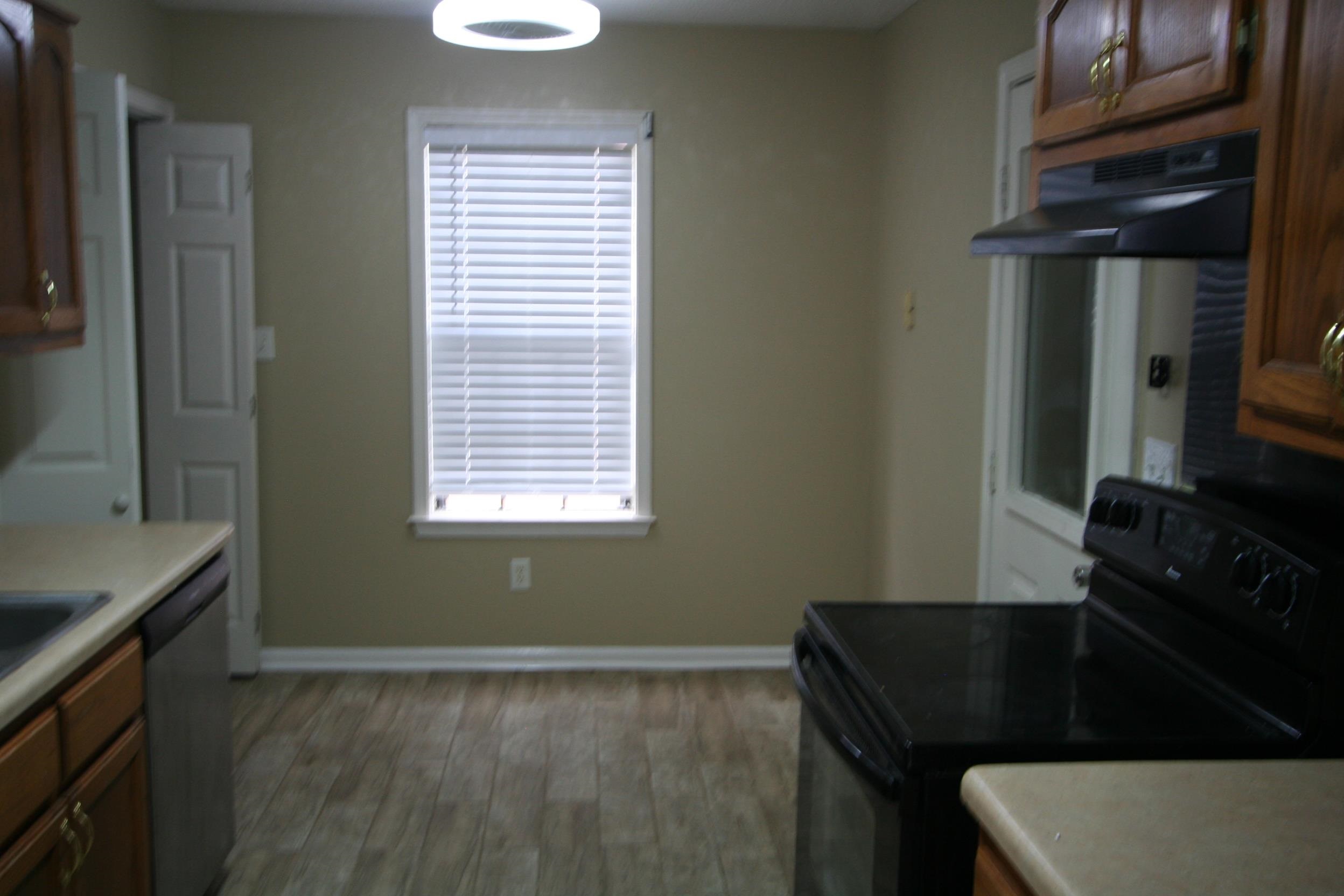 9793 Riggan Drive Olive Branch, MS 38654 - Photo 6 of 7 a kitchen with a sink a stove and a refrigerator