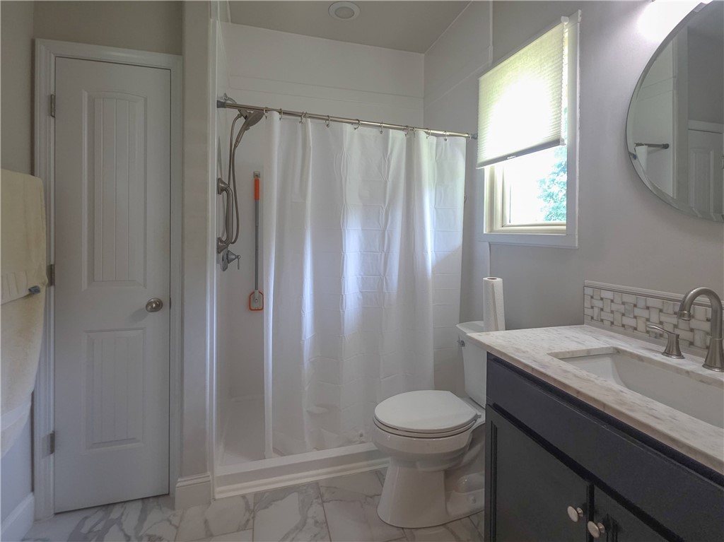 3 Cringle Lane Anderson, SC 29625 - Photo 11 of 26 A well-appointed bathroom features a modern vanity with a marble top, sleek fixtures, and patterned tile accents.