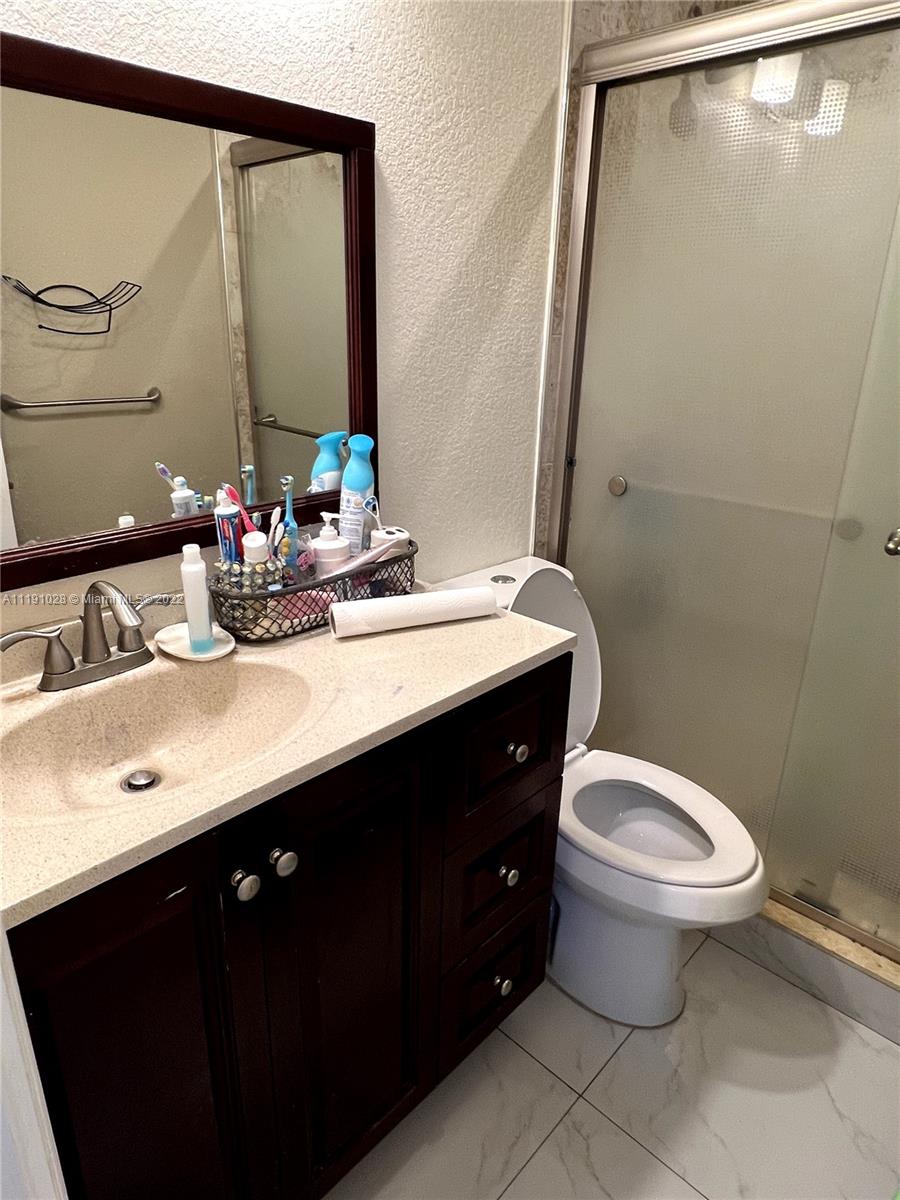 554 West 2nd Street Riviera Beach, FL 33404 - Photo 3 of 11 a bathroom with a sink and a mirror