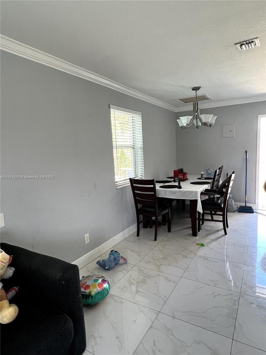 554 West 2nd Street Riviera Beach, FL 33404 - Photo 8 of 11 a view of a workspace with furniture and a window