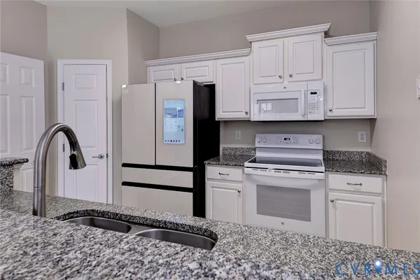 a kitchen with a stove a refrigerator and cabinets