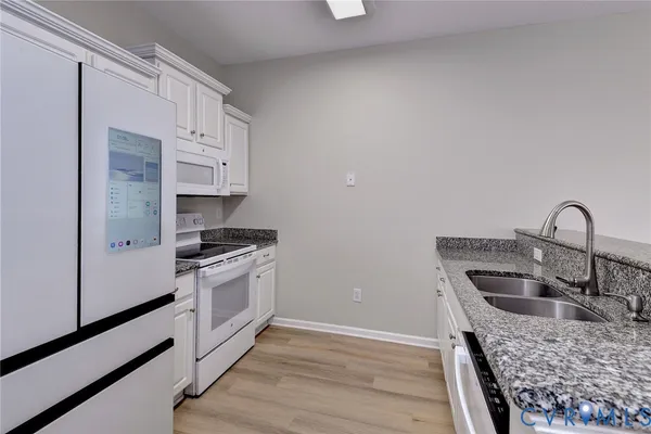 a kitchen with granite countertop a sink and a stove