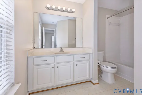 a bathroom with a shower toilet and sink