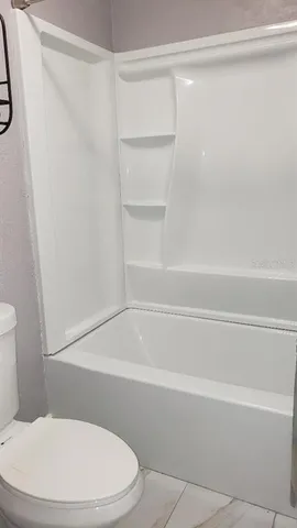 a bathroom with a toilet and a bathtub