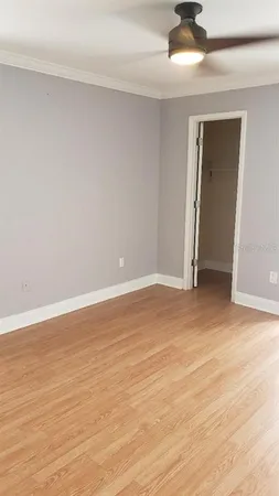 a view of an empty room with wooden floor
