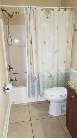 a bathroom with a toilet and shower