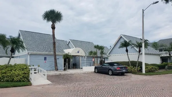 a car parked in front of a house and a small yard