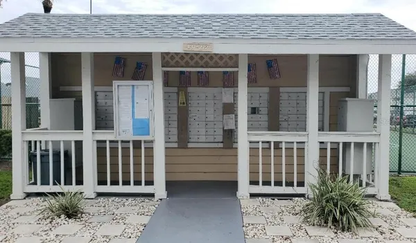 a view of a brick house with plants