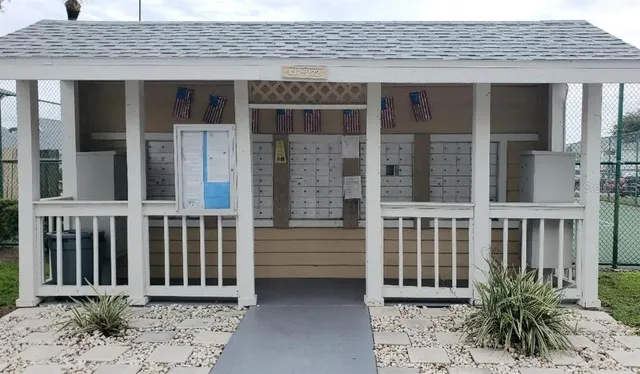 a view of a brick house with plants