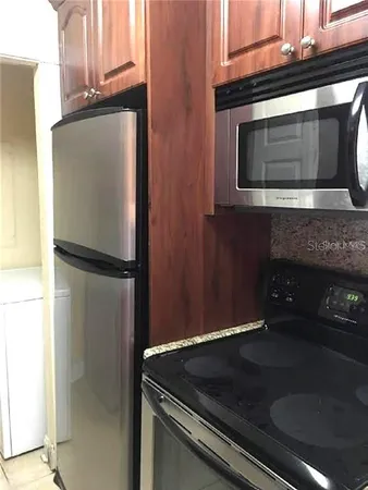 a kitchen with granite countertop cabinets and steel stainless steel appliances