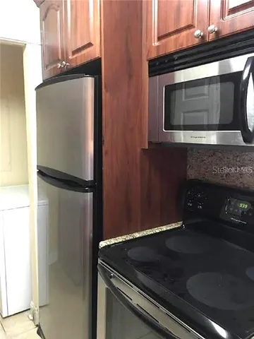 a kitchen with granite countertop cabinets and steel stainless steel appliances