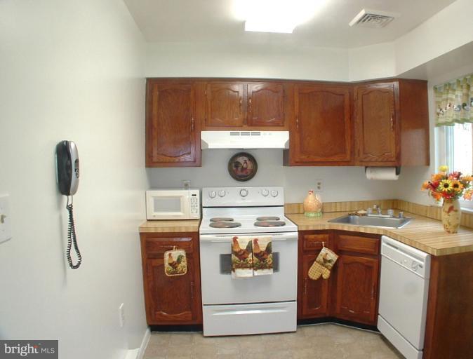 7024 Basswood Road Frederick, MD 21703 - Photo 1 of 12 a kitchen with a stove and a refrigerator