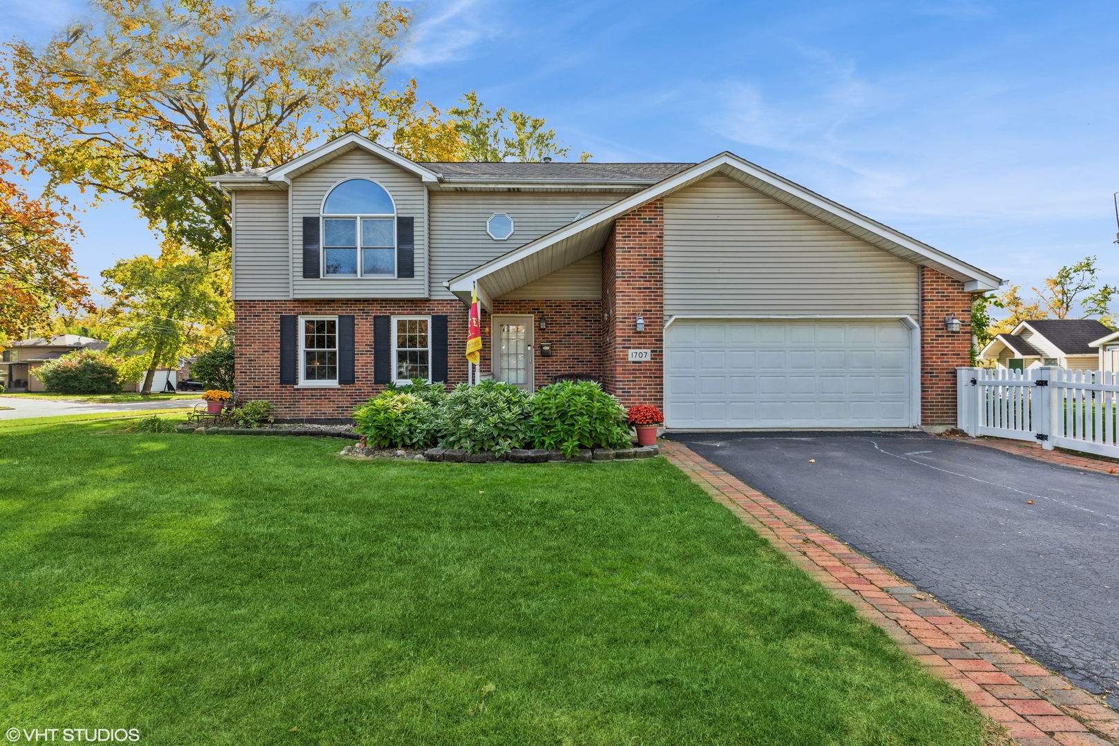 1707 Pine Road Homewood, IL 60430 - Photo 1 of 22 a front view of a house with a yard and garage