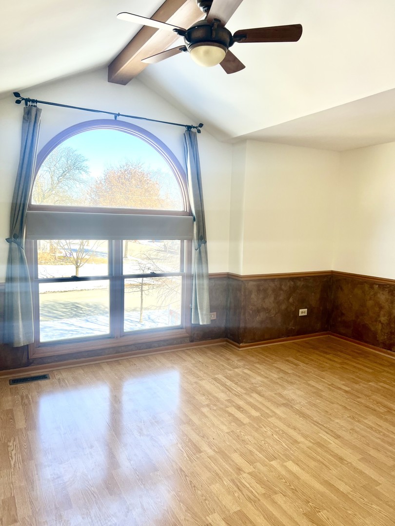 1707 Pine Road Homewood, IL 60430 - Photo 10 of 22 a view of an empty room with a window and kitchen view