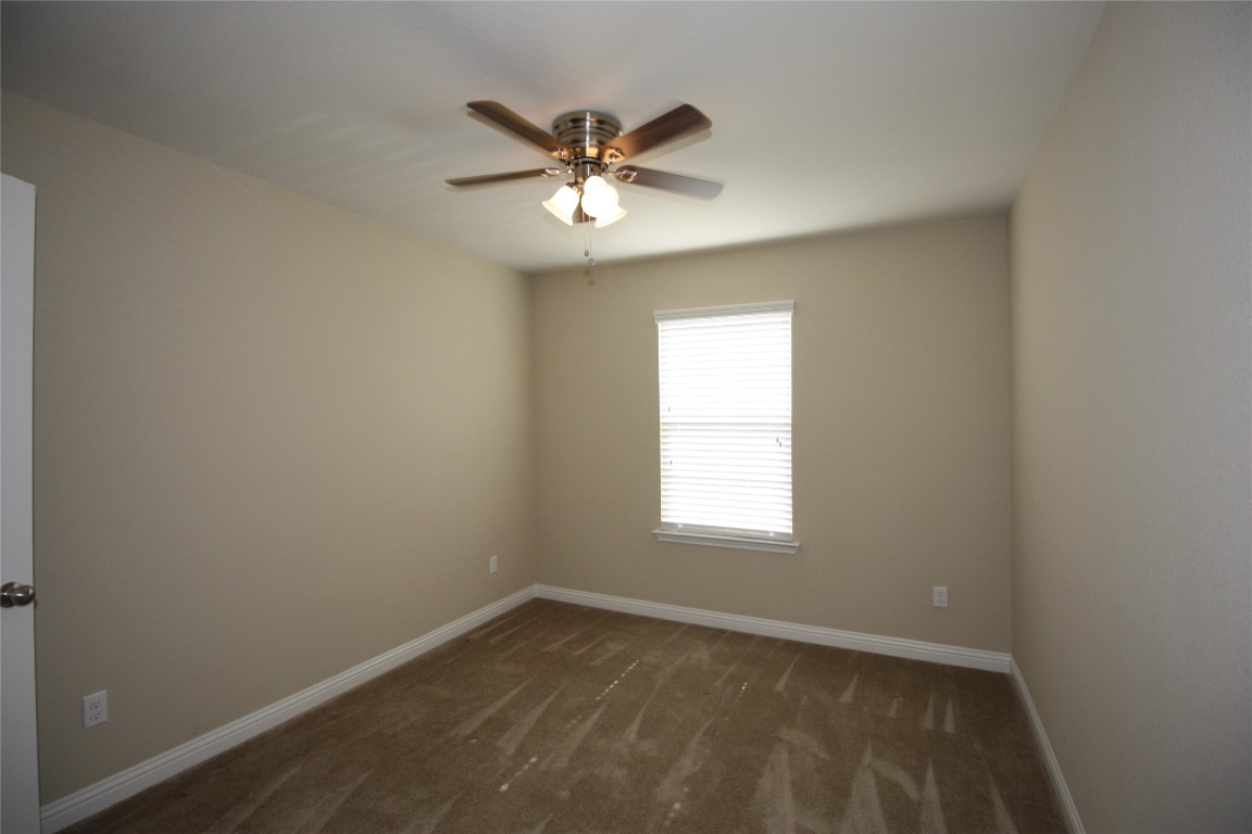 3804 Kennedy Grace Lane Austin, TX 78728 - Photo 14 of 21 an empty room with a window and a fan