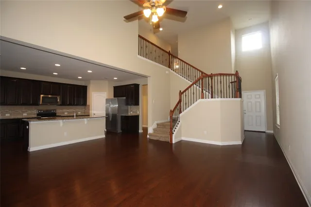 a view of a kitchen with furniture and wooden floor