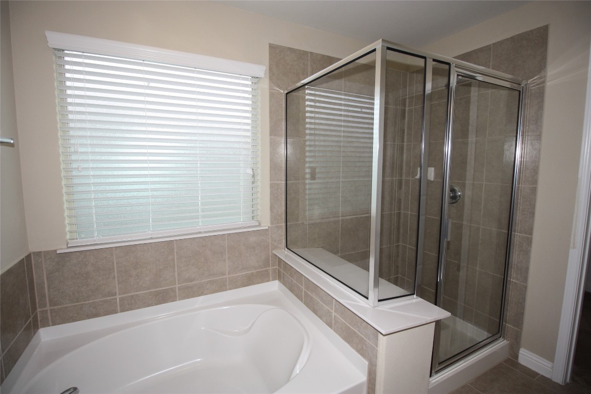 3804 Kennedy Grace Lane Austin, TX 78728 - Photo 9 of 21 a bathroom with a shower and a bathtub
