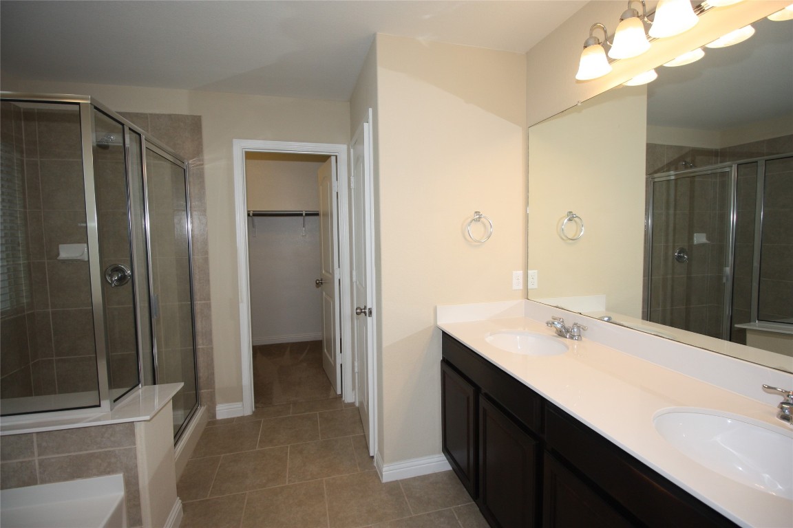 3804 Kennedy Grace Lane Austin, TX 78728 - Photo 10 of 21 a bathroom with a sink a mirror and a shower