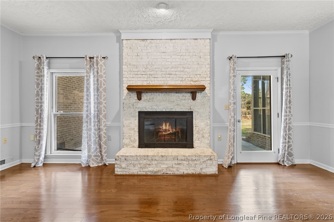 7756 Dragonhead Road Fayetteville, NC 28311 - Photo 33 of 42 a view of a livingroom with wooden floor and a fireplace