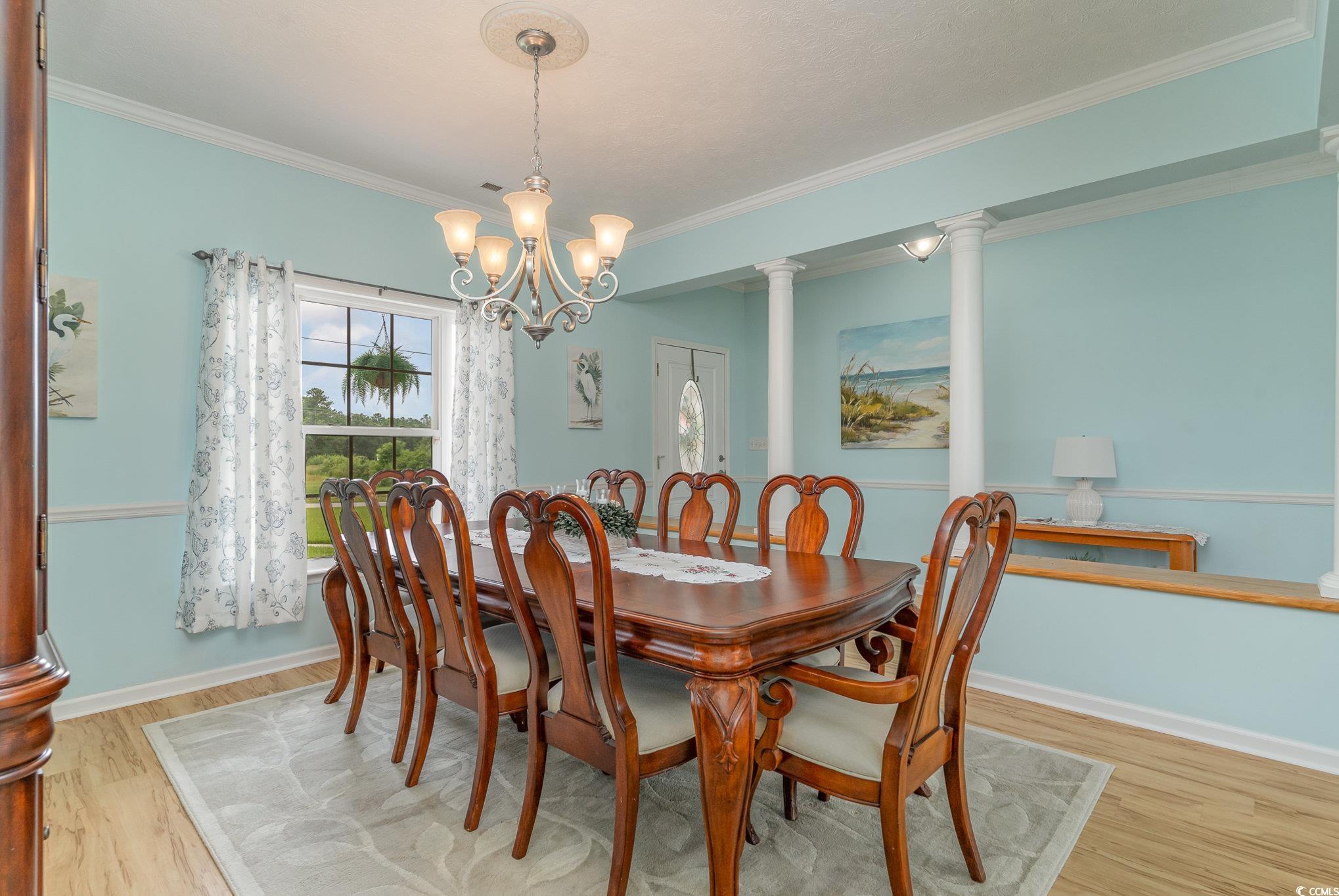 1168 Floyd Page Road Galivants Ferry, SC 29544 - Photo 9 of 37 Dining area with a notable chandelier, light hardw