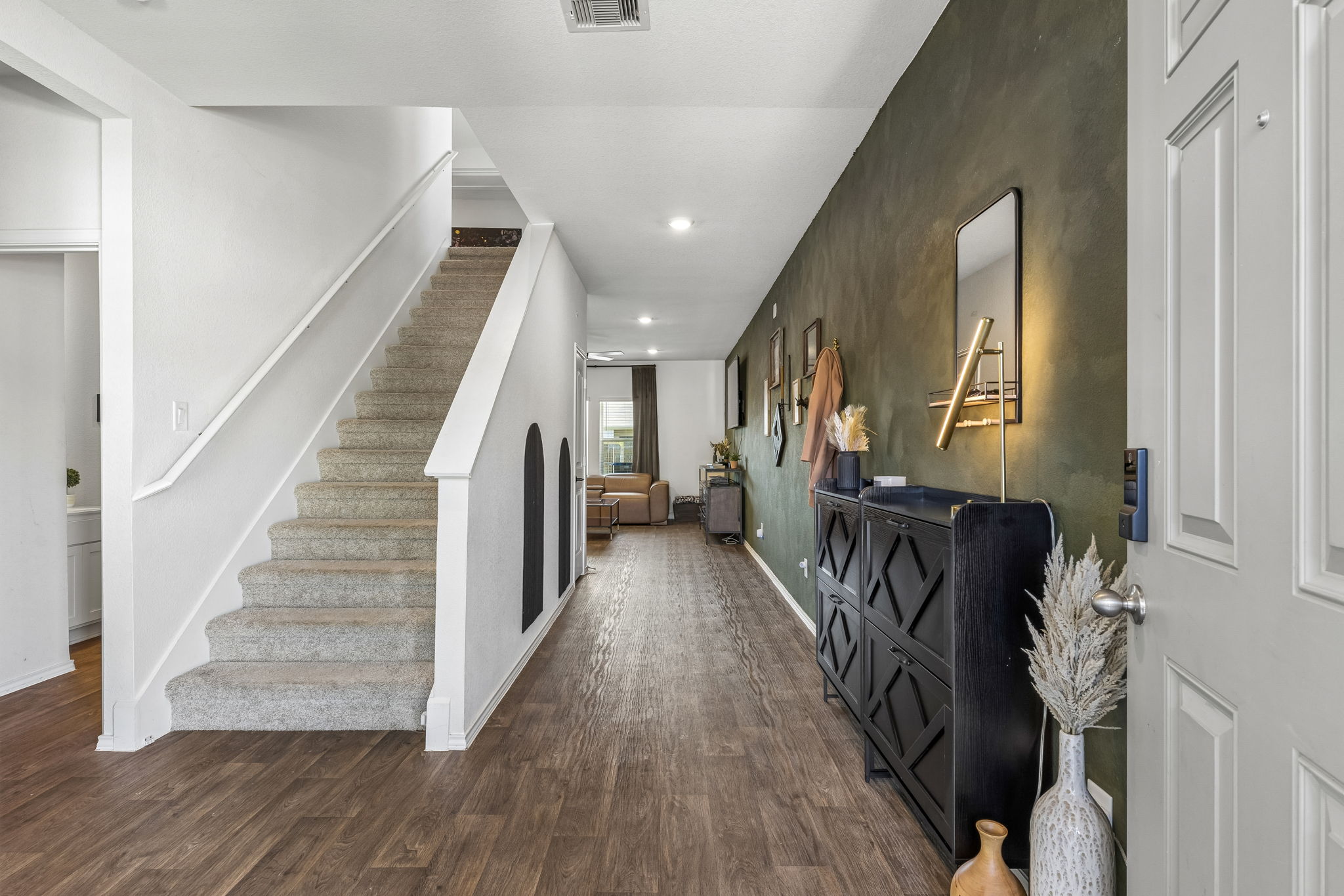 343 Sickle Loop Kyle, TX 78640 - Photo 4 of 40 Entryway featuring wood-finish flooring and a staircase with carpeted treads