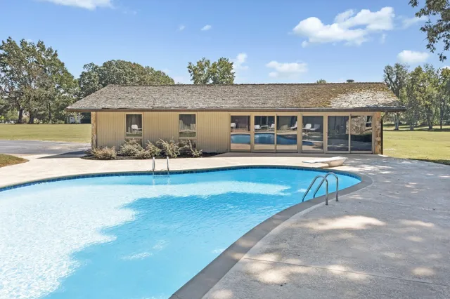 an outdoor space with pool and furniture