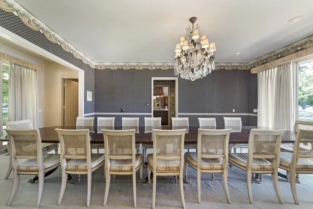 a view of a dining room with furniture and chandelier