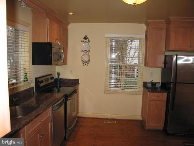 701 Gilmarys Road Baltimore, MD 21210 - Photo 8 of 23 a kitchen with stainless steel appliances granite countertop a sink stove and refrigerator